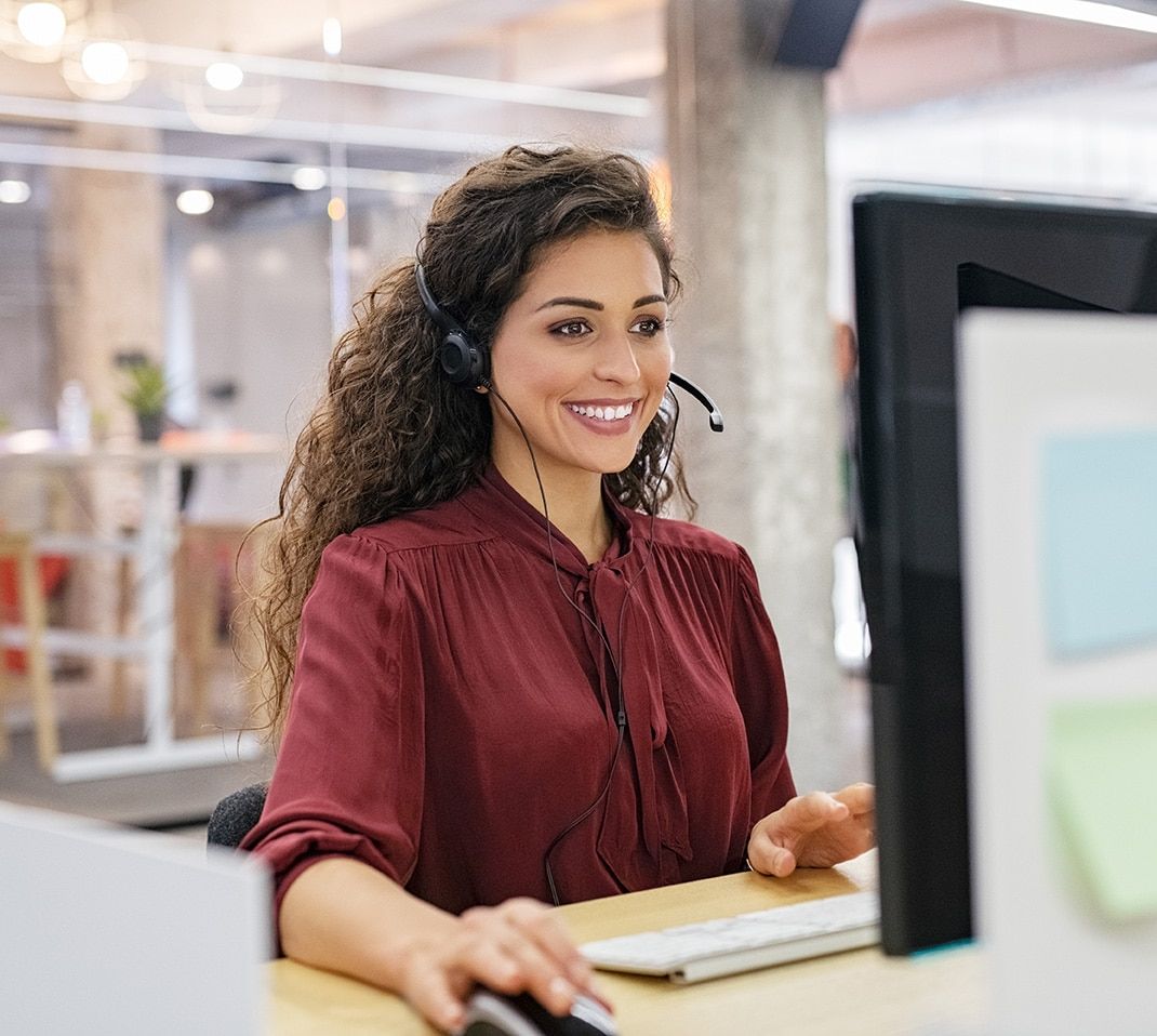 Woman wearing a headset taking a call in a call center